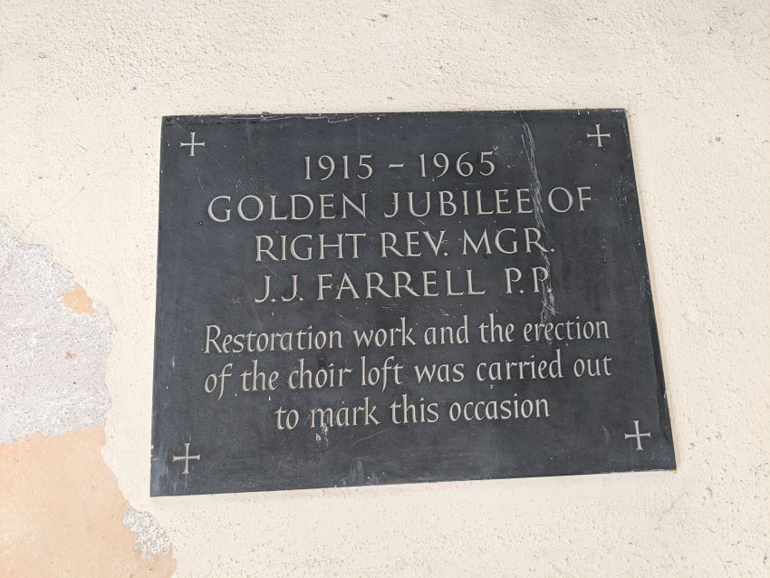 Monsignor Farrell's plaque on the left of the porch